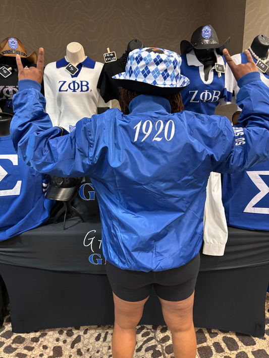 blue jacket with a 'Z' symbol and zippers and 1920 on the back