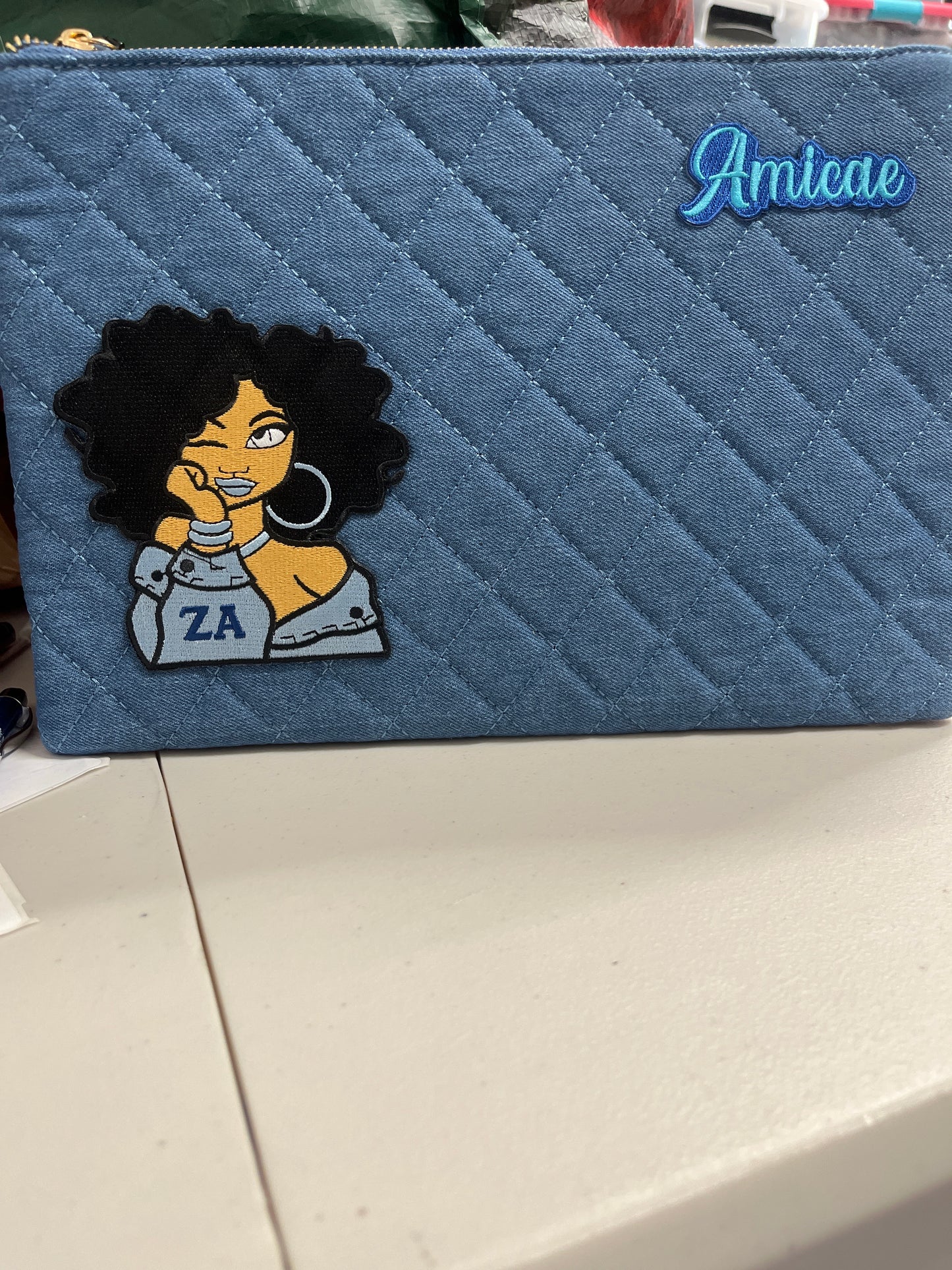 The Amicae Denim clutch