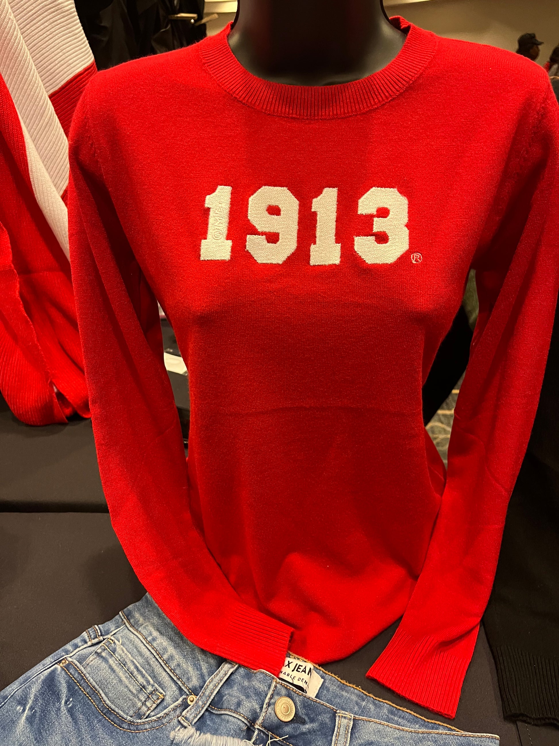 Red Delta Sigma Theta sweater with a luxurious cashmere-like feel, featuring “1913” in white across the front and ΔΣΘ etched on the sleeve. Soft, comfortable, and perfect for showing sorority pride in style.