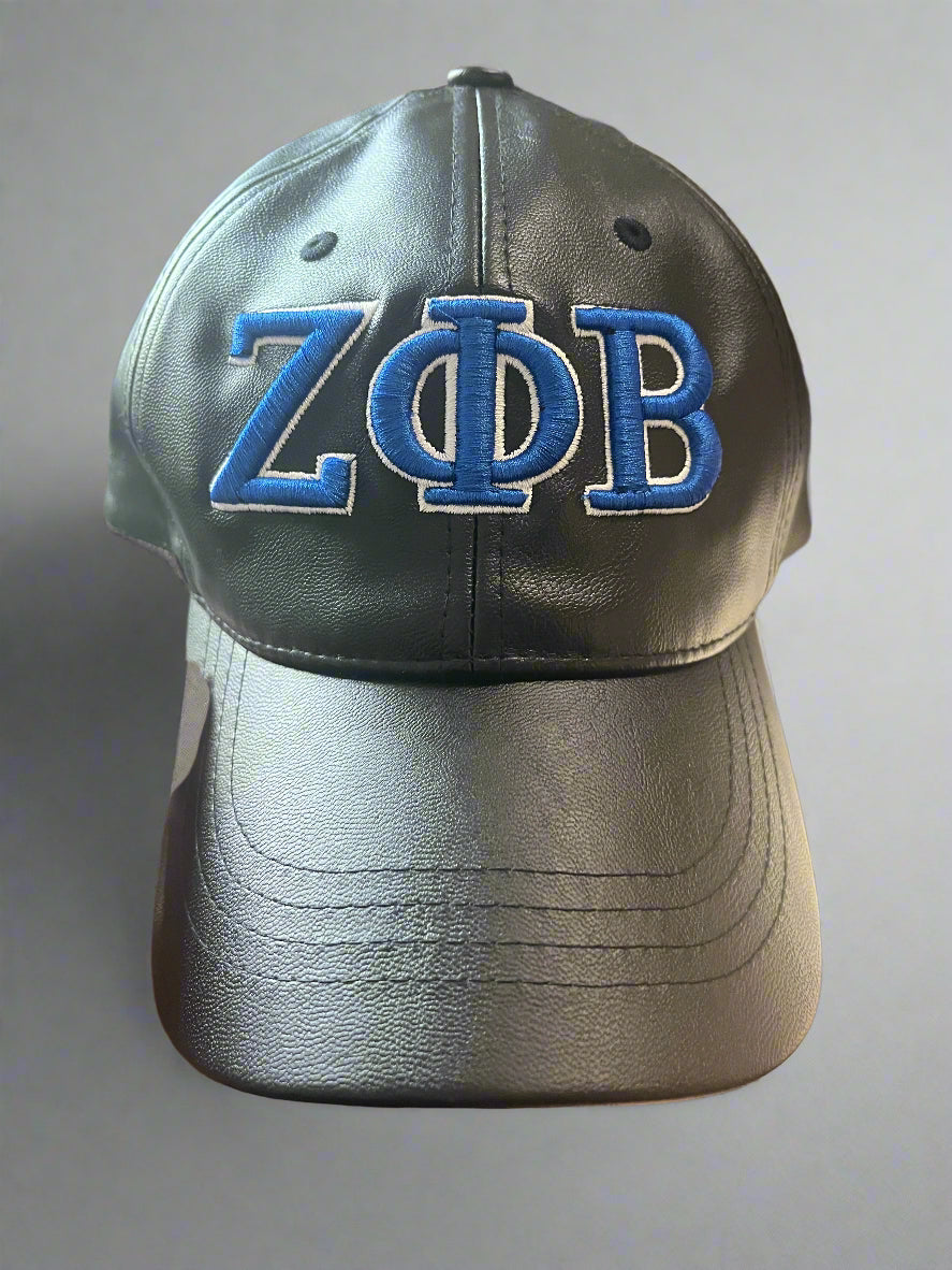 Top off your look with the 3D Zeta Vegan Leather Caps. Made from sleek faux black leather, these caps feature bold 3D Zeta detailing and an adjustable back strap for a comfortable fit. The dark brown strap is barely noticeable, keeping the look clean and stylish.