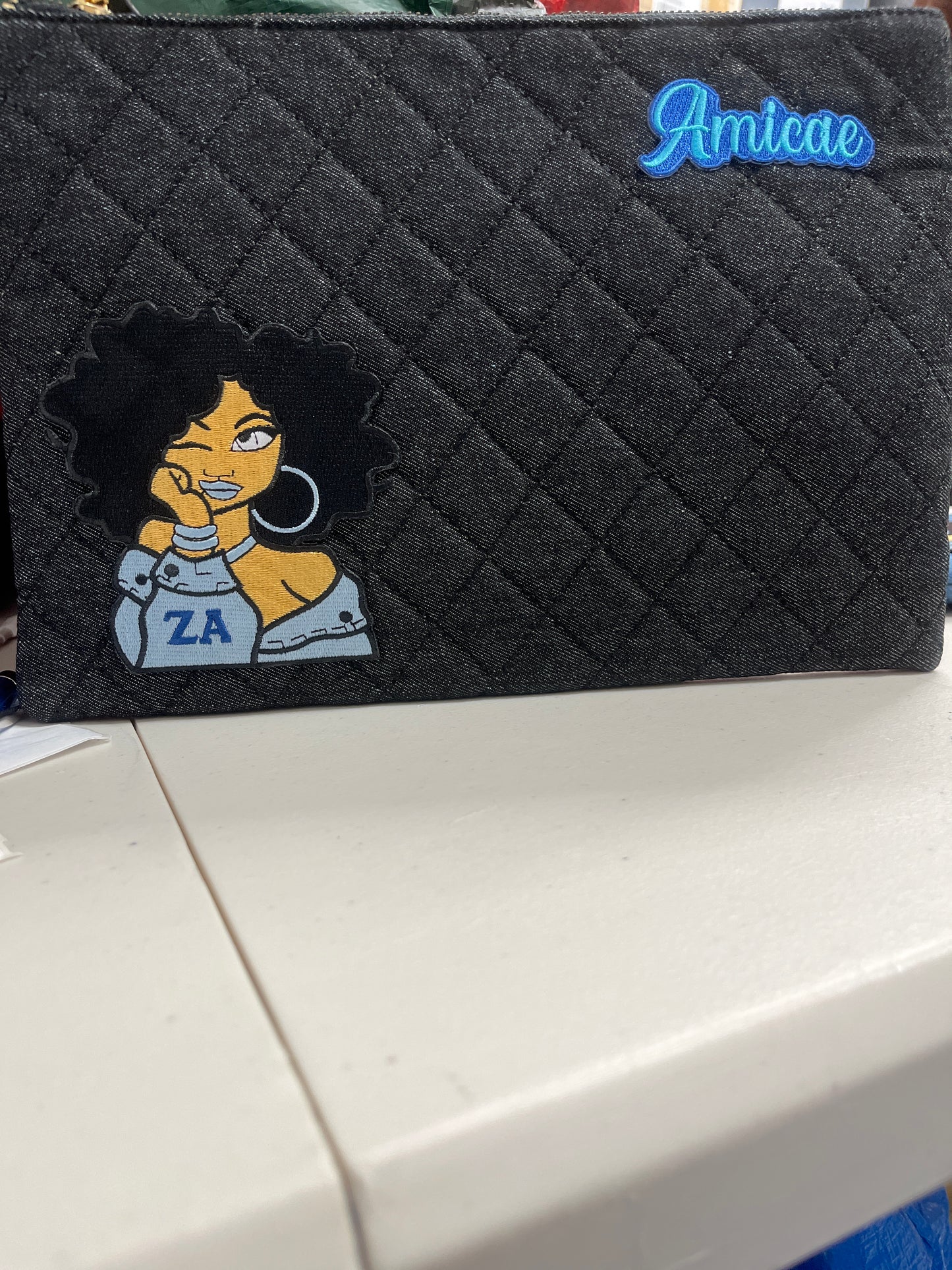 The Amicae Denim clutch
