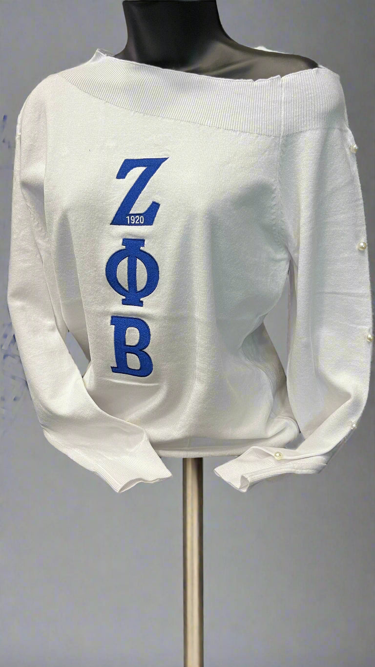 A Little Off The Shoulder is a soft, feminine sweater made for the Finer woman in you. Designed with a subtle off-shoulder fit and five pearls down the sleeve to honor the Five Founders. A beautiful Zeta statement piece for any occasion.