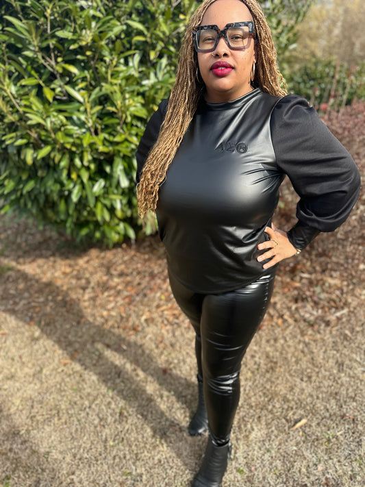 Sleek faux-leather Delta Sigma Theta top designed with soft material sleeves for a bold, sexy look. Features great stretch for a flattering, comfortable fit perfect for stepping out in confident Delta style.