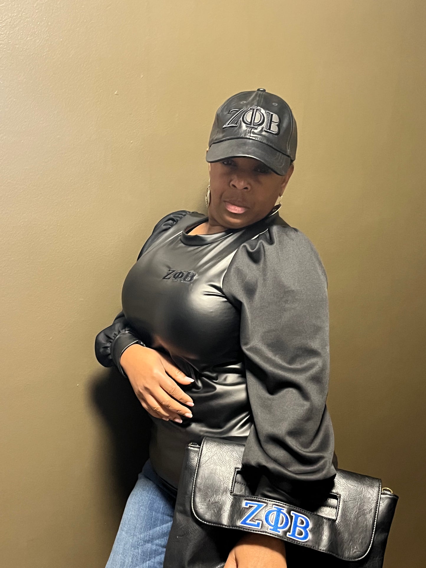 Sleek vegan-leather Zeta Phi Beta top featuring stylish material sleeves for a bold, sexy look. Designed with great stretch for a flattering, comfortable fit. (Top Only)