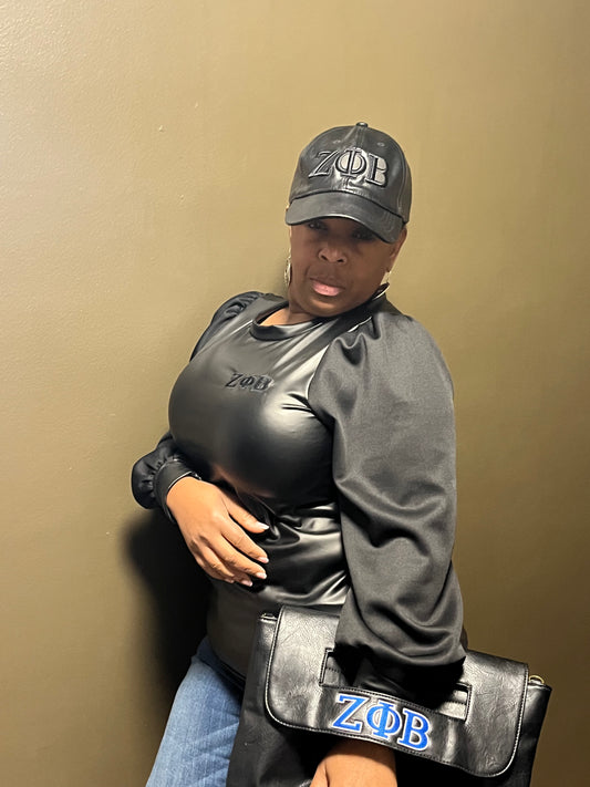 Sleek vegan-leather Zeta Phi Beta top featuring stylish material sleeves for a bold, sexy look. Designed with great stretch for a flattering, comfortable fit. (Top Only)