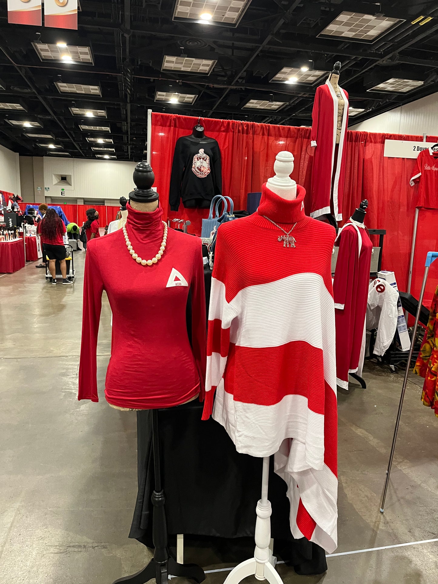 Asymmetrical Delta Sigma Theta sweater featuring a sleek one-sleeve turtleneck shawl design with an open side for a bold, modern look. Finished with DST detailing on the collar, this piece blends comfort, Greek pride, and standout style.
