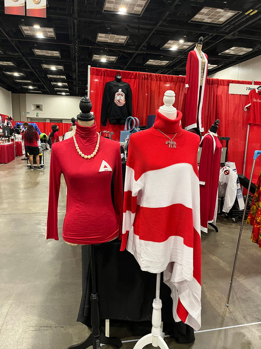 Asymmetrical Delta Sigma Theta sweater featuring a sleek one-sleeve turtleneck shawl design with an open side for a bold, modern look. Finished with DST detailing on the collar, this piece blends comfort, Greek pride, and standout style.