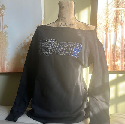 Step out in style with this off-the-shoulder sweatshirt featuring dazzling Soror bling. Perfect for casual days or Sorority events, it’s cozy, cute, and made to fit comfortably size up for your ideal look. 