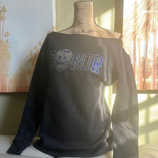 Step out in style with this off-the-shoulder sweatshirt featuring dazzling Soror bling. Perfect for casual days or Sorority events, it’s cozy, cute, and made to fit comfortably size up for your ideal look. 