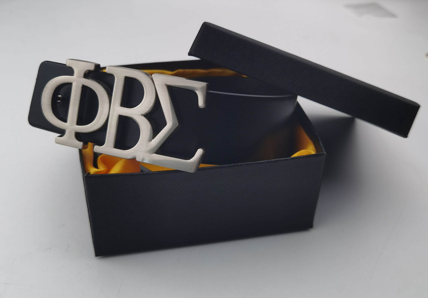 Elevate your Fraternity style with this designer Phi Beta Sigma Name Belt, featuring a bold stainless steel ΦΒΣ buckle paired with a sleek leather strap. Durable, polished, and statement-making, it’s the perfect accessory for conferences, chapter events, or everyday Sigma pride.