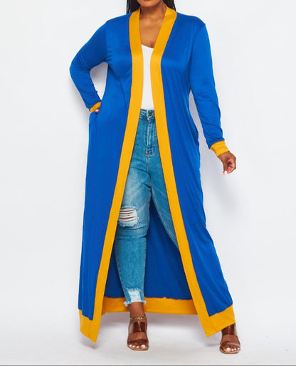 The Rho Duster is a long, royal-blue layering piece with bold yellow trimming. It fits true to size for an easy, flattering silhouette. Perfect for any SGRHO look that needs a little extra flair.