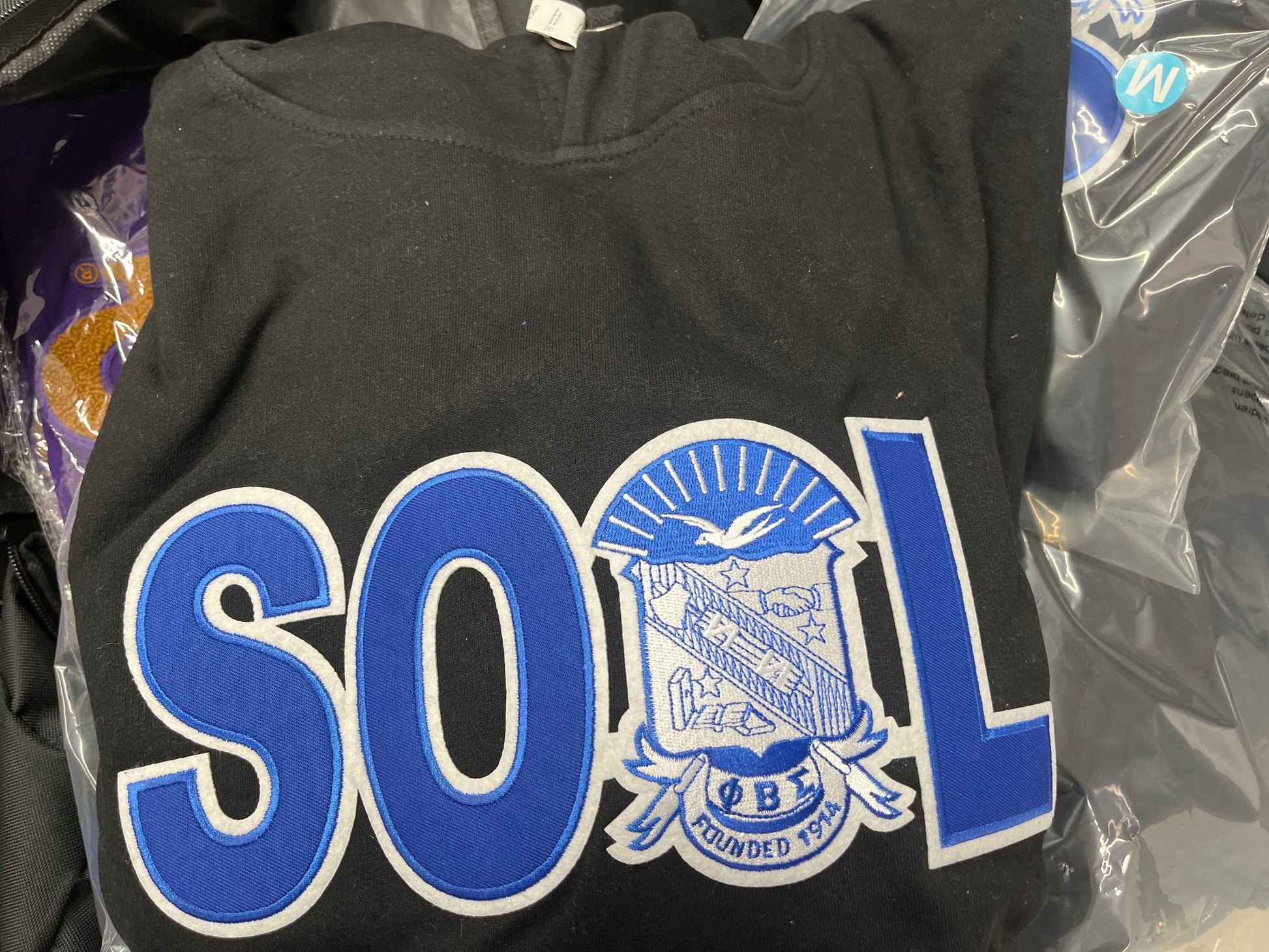 Black phi beta sigma sweatshirt with blue and white text and logo 