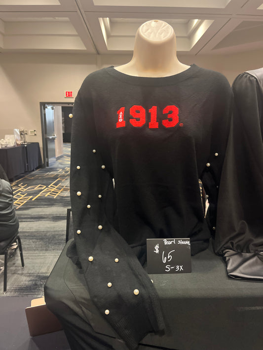 Fabulous Delta Sigma Theta sweater with a luxurious cashmere-like feel, featuring “1913” on the chest and delicate pearls etched into the fabric sleeves. Soft, stylish, and perfect for showing sorority pride with a touch of elegance.