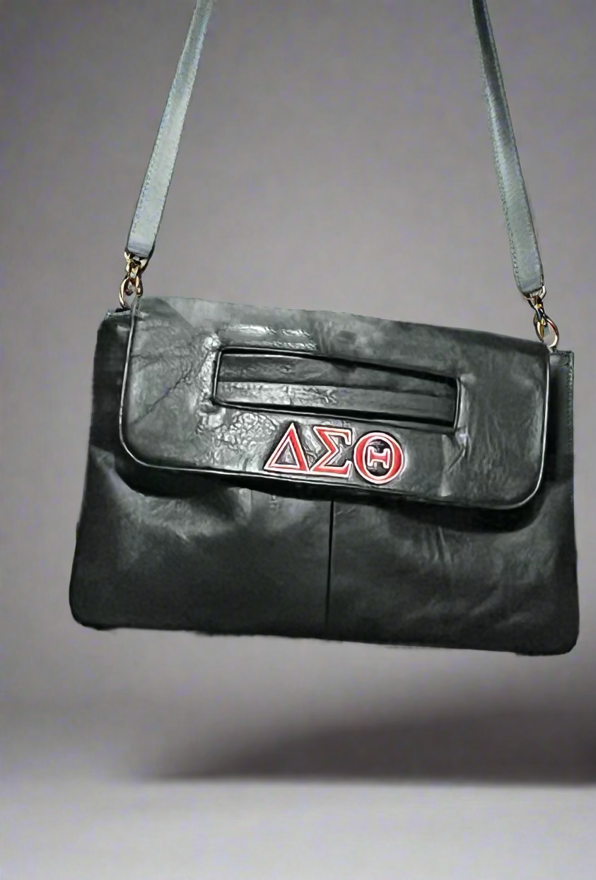 Show off your Delta pride with this stylish crossbody bag, available in Black and Red. Featuring the Delta Sigma Theta insignia and a convenient crossbody attachment, it’s perfect for everyday wear or Soror events. 