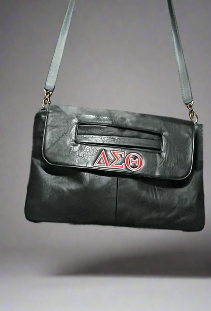 Show off your Delta pride with this stylish crossbody bag, available in Black and Red. Featuring the Delta Sigma Theta insignia and a convenient crossbody attachment, it’s perfect for everyday wear or Soror events. 