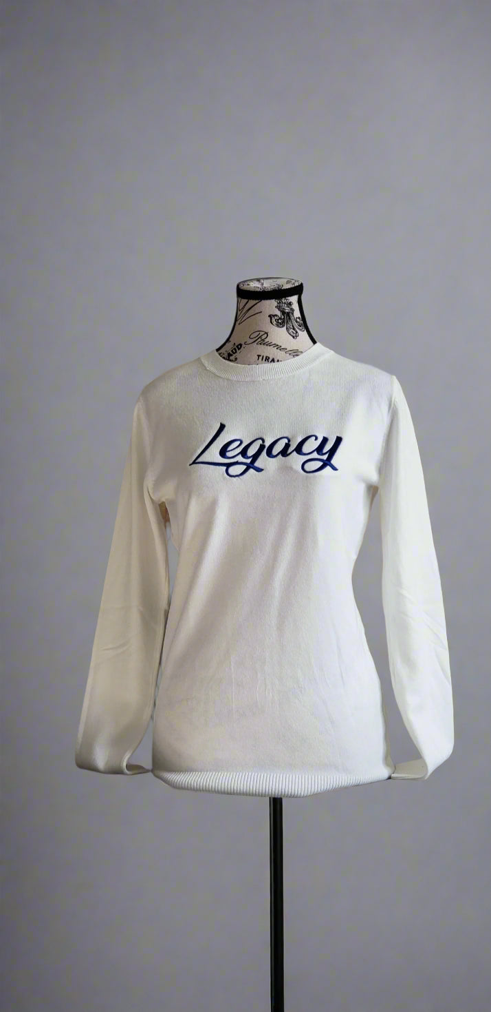 The Zeta Legacy Sweater is a soft white knit featuring bold royal-blue “Legacy” lettering on the front. Comfortable, stylish, and perfect for honoring your Zeta roots. A timeless piece for any Finer legacy.
