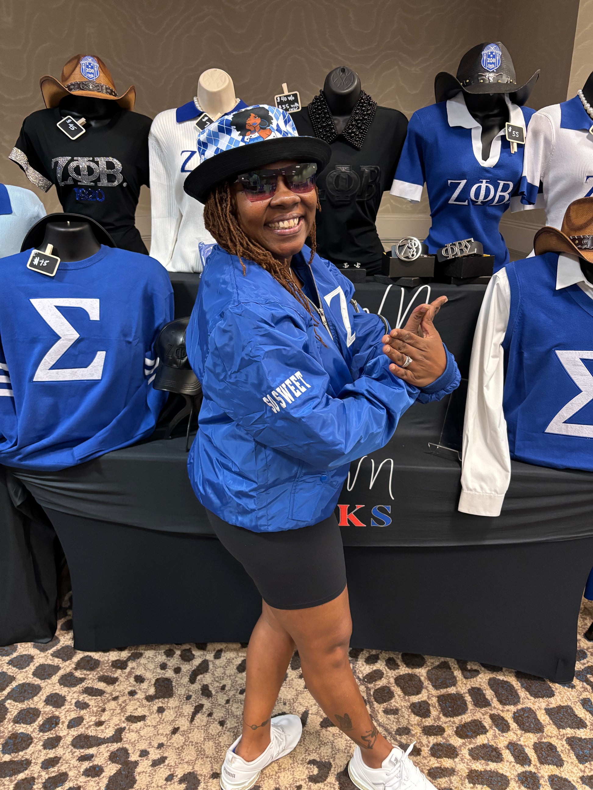 woman in blue jacket with a 'Z' symbol and zippers. zeta phi beta
