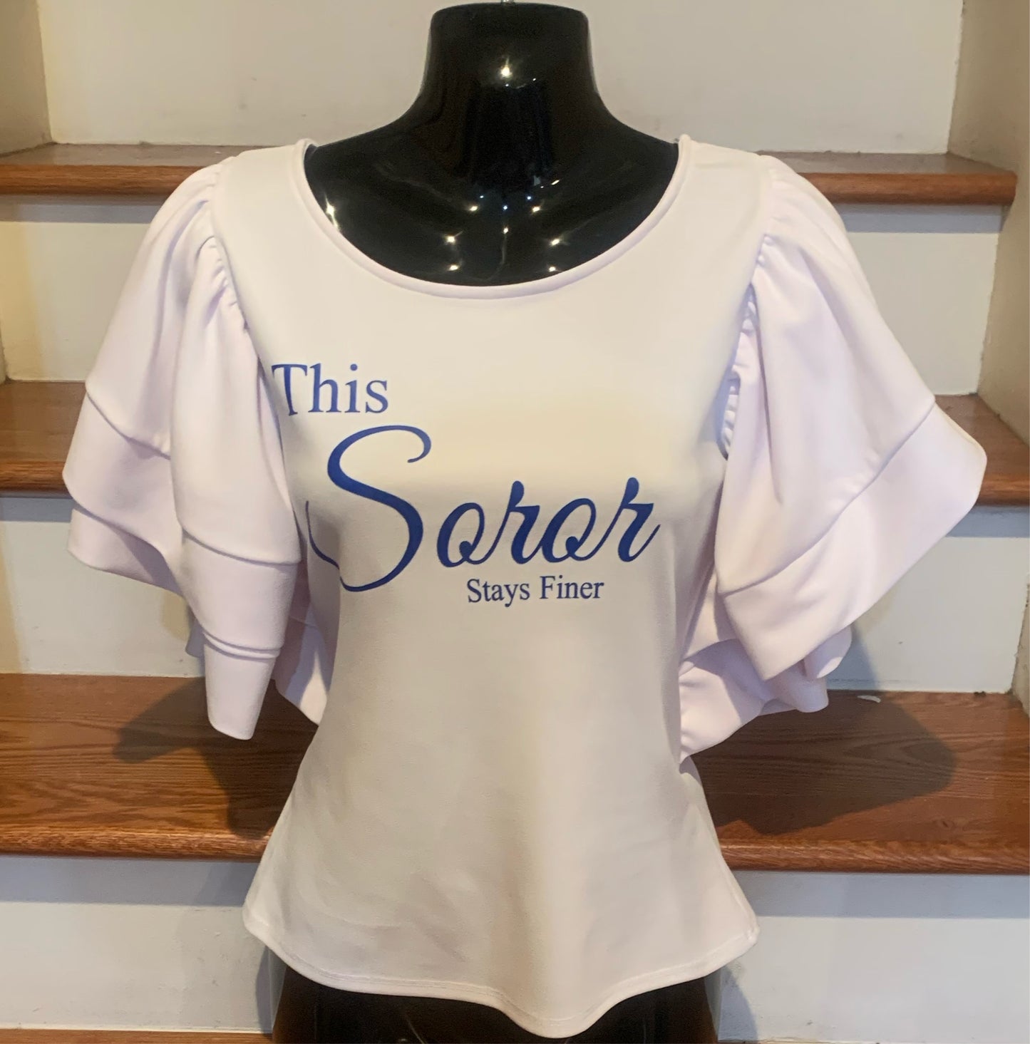 Elevate your style with the Finer Soror Blouse, an all-white blouse featuring elegant, ruffled sleeves and a plunging back for a look that’s both sexy and classy. Perfect for brunches, events, or a stylish day out, this blouse combines sophistication with a touch of boldness. 