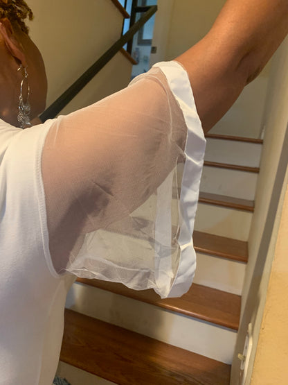 Soft cotton-spandex blend with sheer ruffled sleeves for a playful, feminine look. Stretchy, comfortable, and easy to style for casual or dressy occasions. Available in black and white.