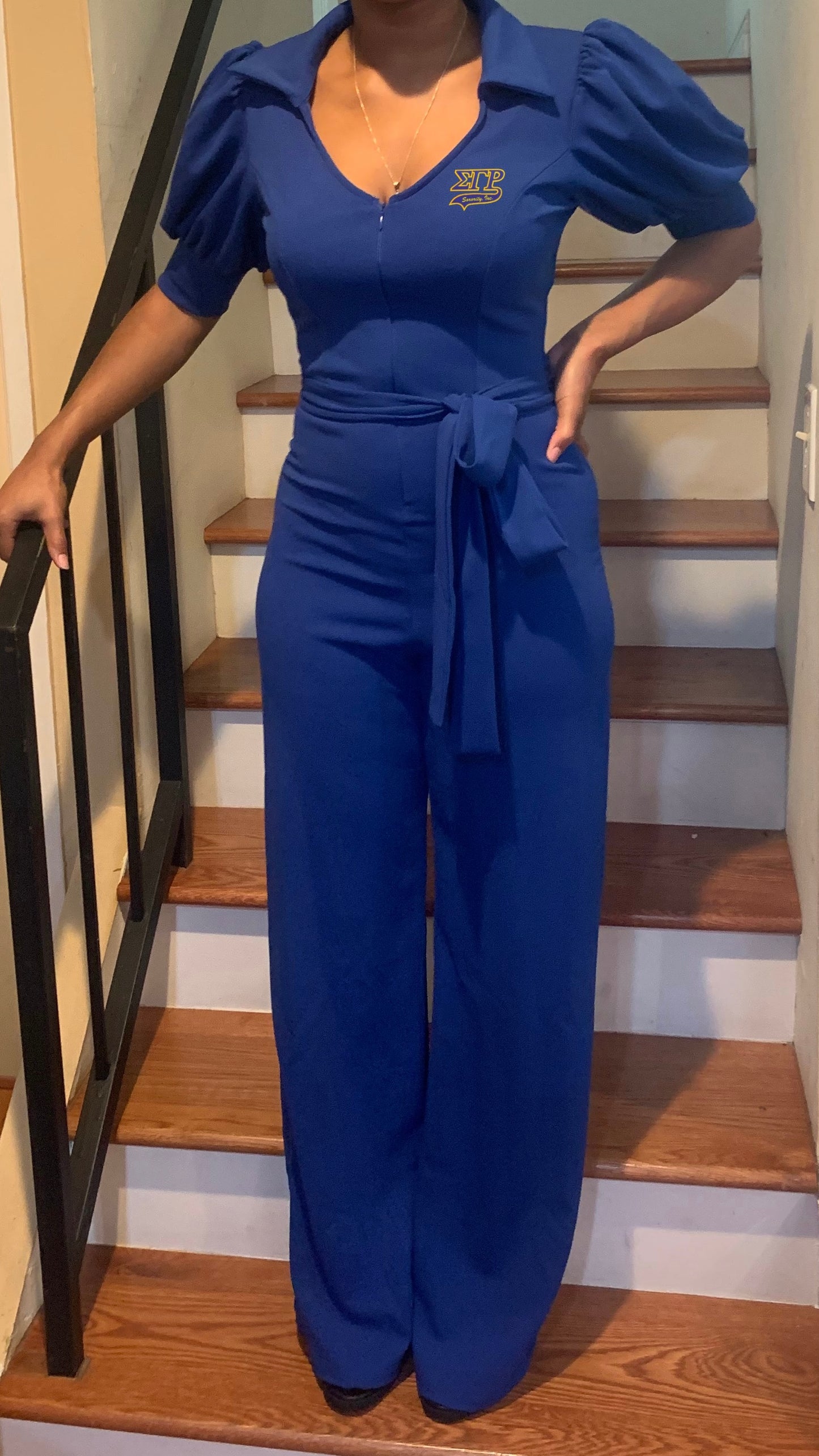 Step out in style with the SGRHO Jumpsuit, a one-piece outfit featuring a front zipper closure and Snow-White sleeves. Designed to fit true to size, this jumpsuit is perfect for Soror events or any occasion where you want a chic, polished look.