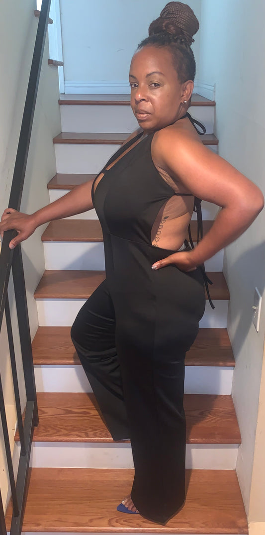 A sleek, curve-hugging black piece with a daring front cutout and halter neckline. Soft satin finish for a bold, confident look that shines day or night.
