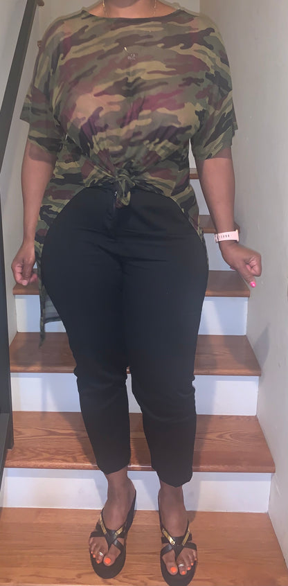 Sheer camouflage high-low top featuring short sleeves and a front tie detail. 