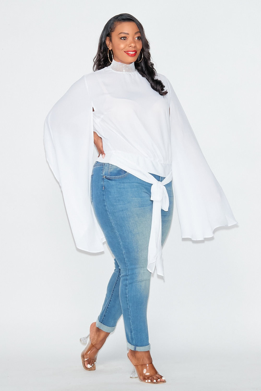 white sheer blouse featuring dramatic sleeves and a studded collar. Chic, bold, and perfect for any occasion.
